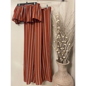 Like new. 2 piece jumpsuit. Orange with black stripes. Size medium.